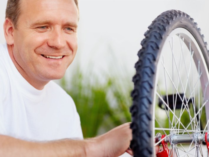 Ein Mann repariert ein Rad von einem Fahrrad, &copy; Stadt Wolfratshausen